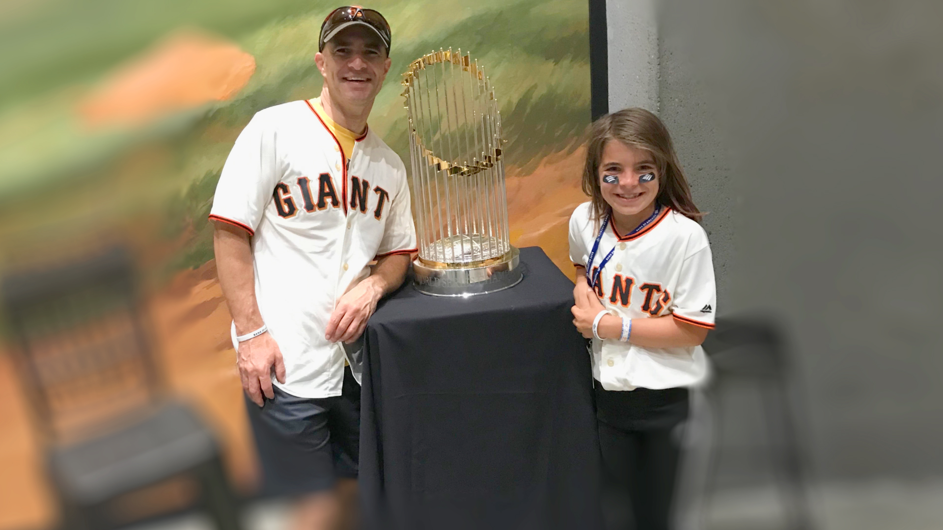 Sebastian and his daughter with the World Series trophy that the San Francisco Giants Major League Baseball team won back in 2014. (Image supplied)