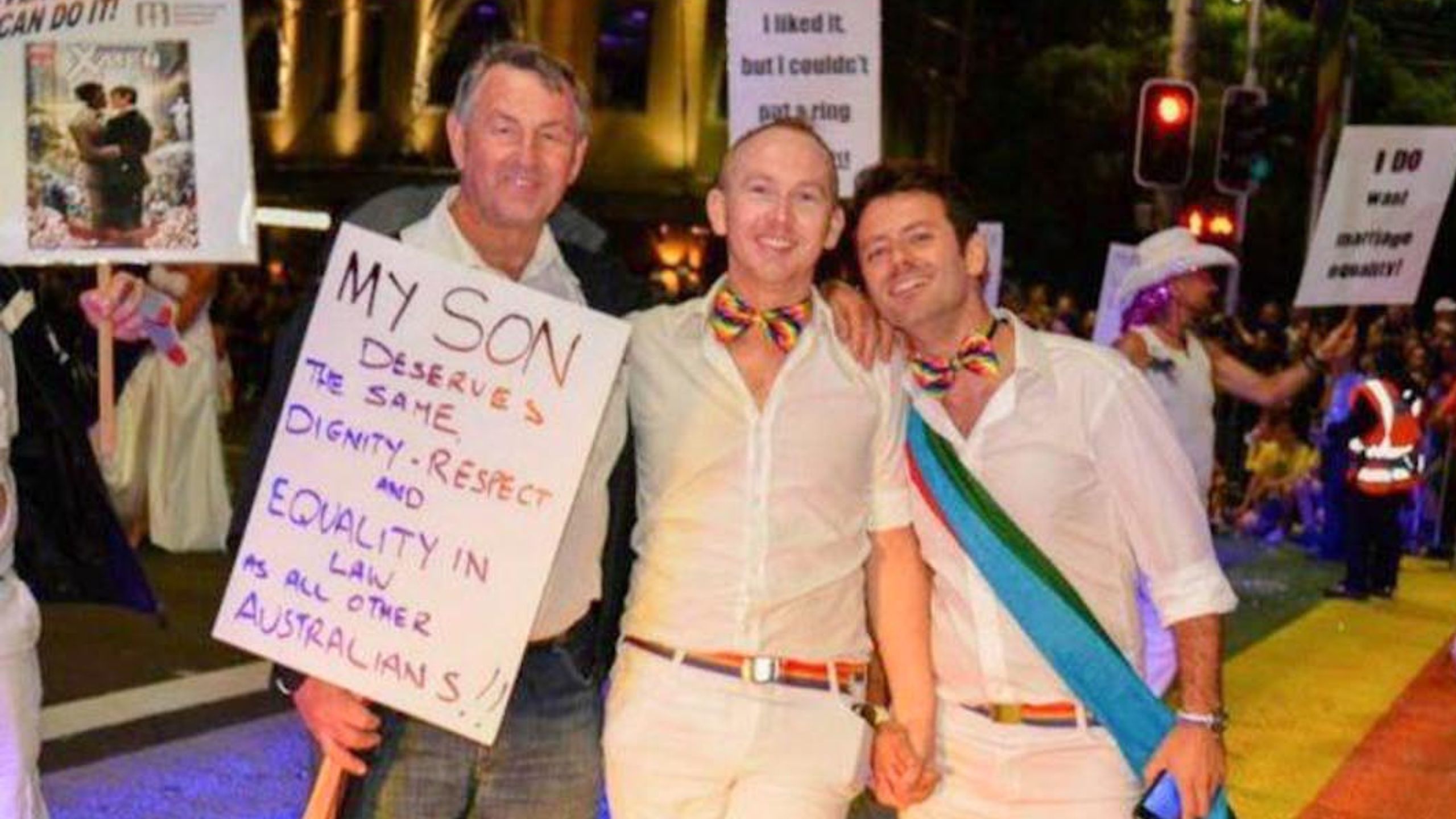 Nathan with his father, Geoff, and now husband, Maikol, during the parade. Nathan describes his dad as his biggest advocate and supporter. (Source: supplied)