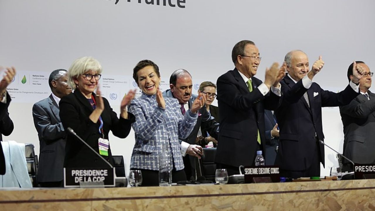Leaders applauding the agreements reached at the Paris climate conference in December 2015. Wider adoption of green energy technologies will go a long way to reaching these goals.